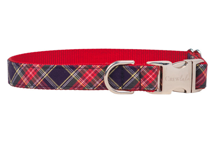 Classic tartan dog collar in red and navy, constructed with durable red nylon backing and finished with metal hardware including a side-release buckle and leash ring.