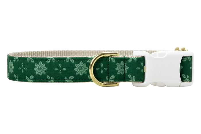 Floral dog collar crafted from green fabric with a light green symmetrical flower and dot pattern. The collar is constructed with a nylon woven backing and includes sleek hardware: a branded buckle with “Crewlala” text and a matching D-ring for attaching accessories.
