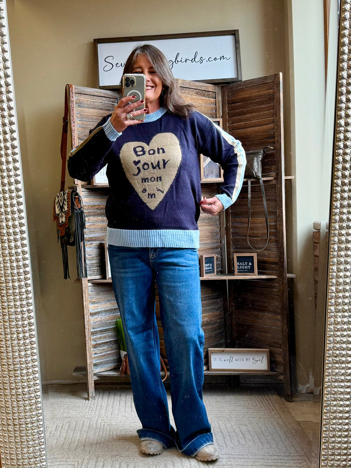 Navy knit sweater with heart graphic, long sleeves and ribbed hem and cuffs