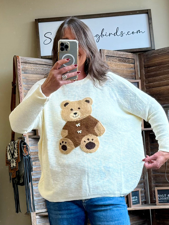 Oversized cream crew neck sweater with teddy bear graphic and long sleeves