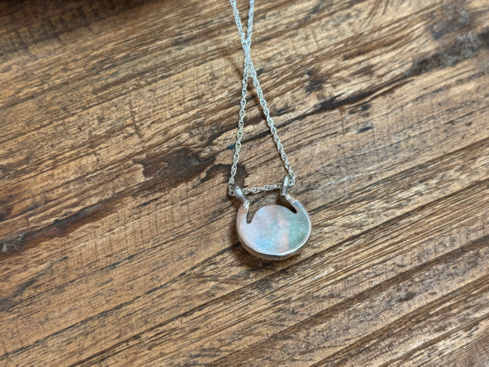 Turquoise horseshoe pendant necklace with round coin-style medallion centerpiece