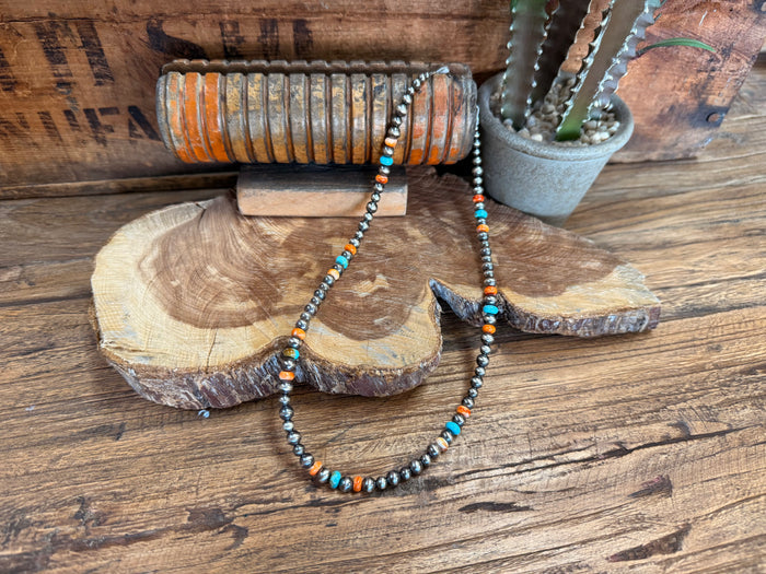 Sterling silver beaded necklace with turquoise and orange accents, adjustable chain