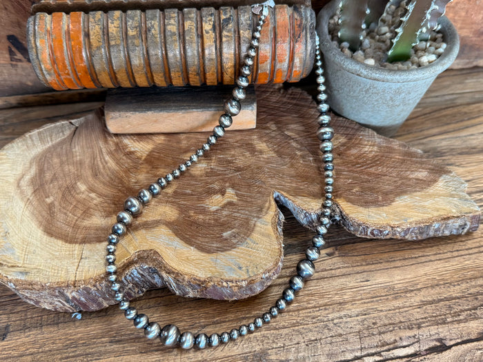 Sterling pearl necklace with graduated bead strand and textured leaf pendant
