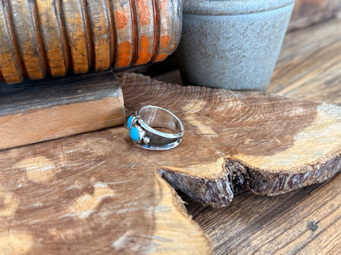 Silver cigar band ring with three turquoise stones on the face