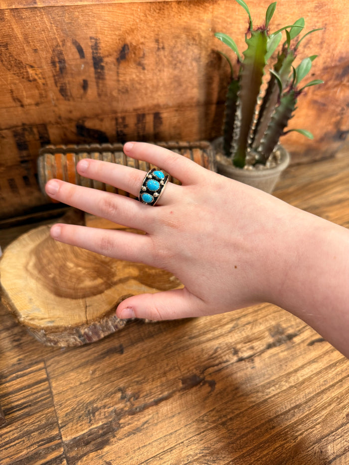 Turquoise three-stone silver ring on hand