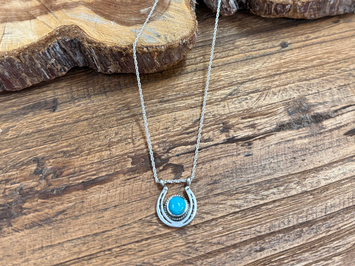 Turquoise horseshoe pendant necklace on silver-tone chain, oval turquoise inset