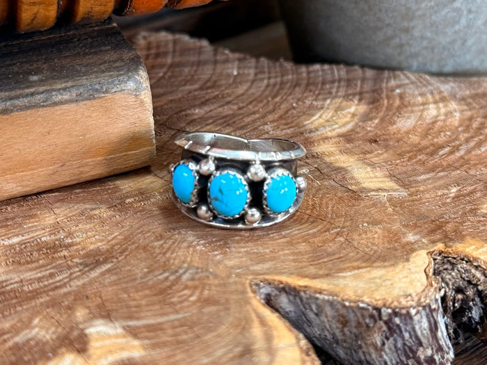 Silver cigar band ring with three bright turquoise oval stones