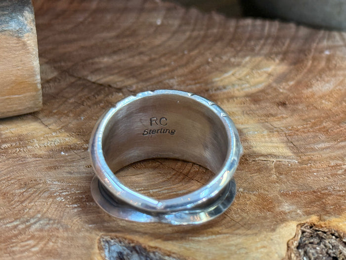 Silver ring interior stamped with markings