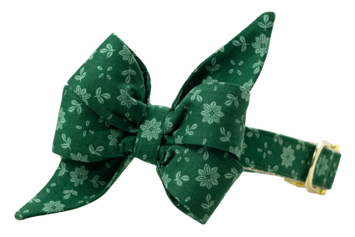 Floral dog collar in deep green, paired with an eye-catching, large feminine belle bow featuring the same light green flower and leaf print. The belle bow is centered and sculpted with folded loops and elongated pointed ends, while the collar includes  adjustable hardware.
