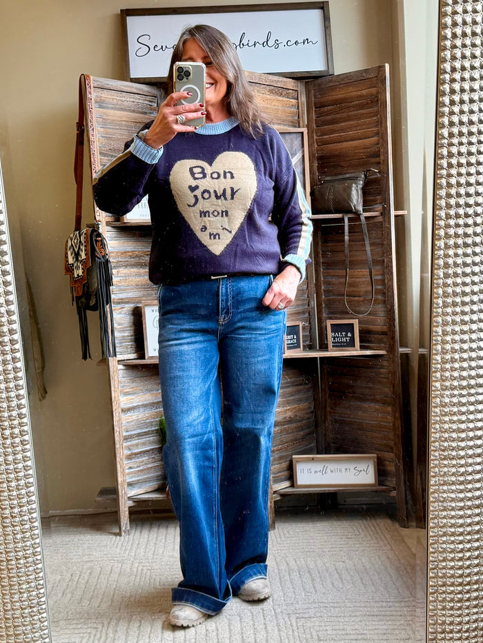 Navy heart-print knit sweater with ribbed collar, hem, and cuffs