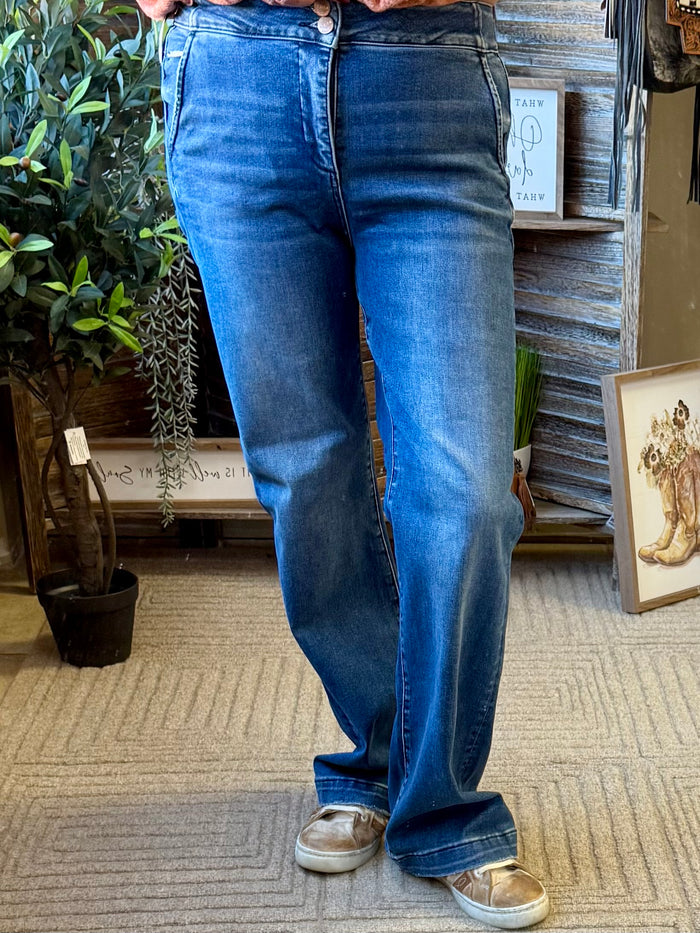 Women's medium-wash denim jeans, front button closure with belt loops and pockets