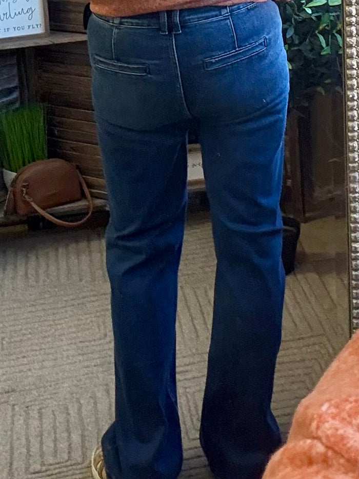 Women's dark-wash denim jeans, back view with belt loops and back pockets