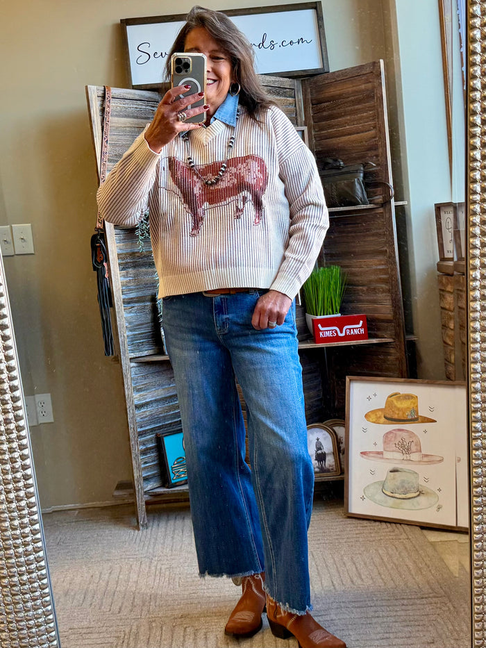 V-neck knit sweater in cream with striped pattern and large reindeer graphic on chest