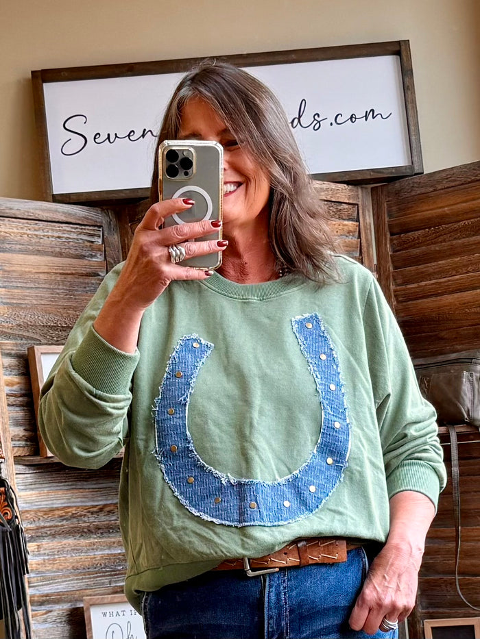 Oversized green cotton sweatshirt with denim horseshoe graphic on crew neck