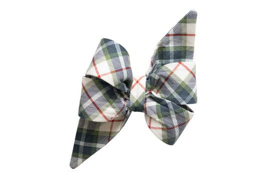 Fabric belle bow with long pointed tails in a light base featuring classic tartan plaid pattern accented with fine diagonal stripes. The belle bow has a structured, layered design with a central knot band in matching plaid fabric, giving it a crisp, festive appearance.