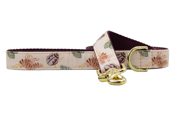 Take your walkies up a notch with this bug-tiful Crewlala leash, featuring a soft pink background, playful insect illustrations, and shiny accents that scream fashion-forward fur baby.
