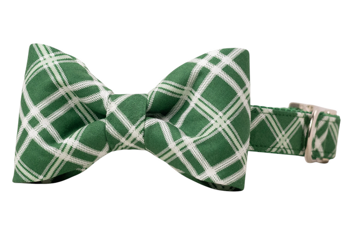 Classic green bow tie for dogs, with intersecting light plaid lines, crafted from smooth fabric and secured to a coordinating green collar with polished hardware.