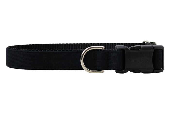 A solid black adjustable dog collar made of durable nylon webbing with reinforced stitching. The collar features a matte black plastic side-release buckle, a metal D-ring and a subtle, sleek design.