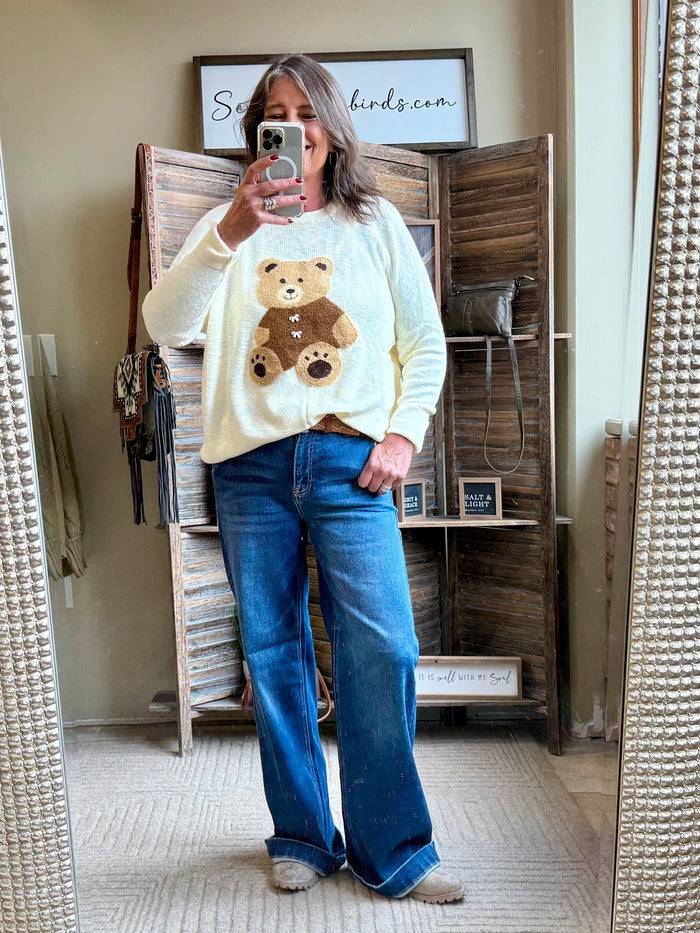 Oversized cream crew neck sweater featuring teddy bear front graphic